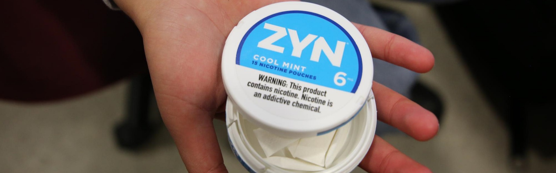 Hand holding ZYN 6mg Cool Mint Nicotine Pouch – Strong and Tobacco-Free